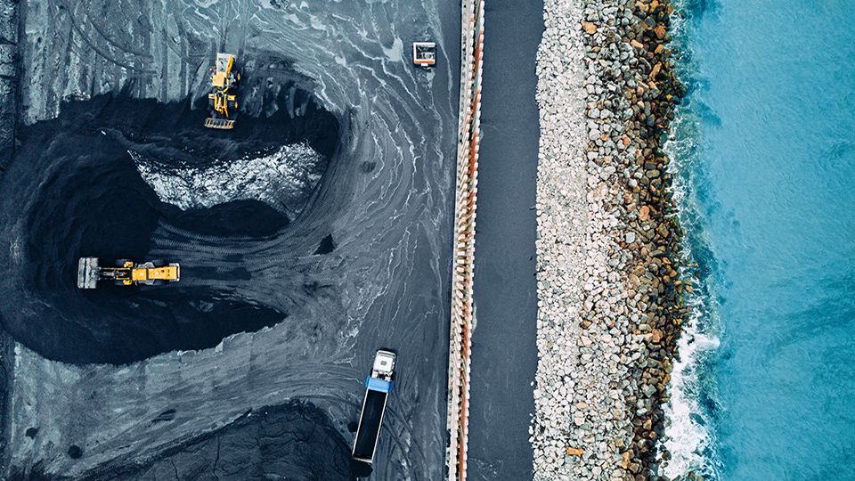 Aerial view of a coal mine next to a shoreline