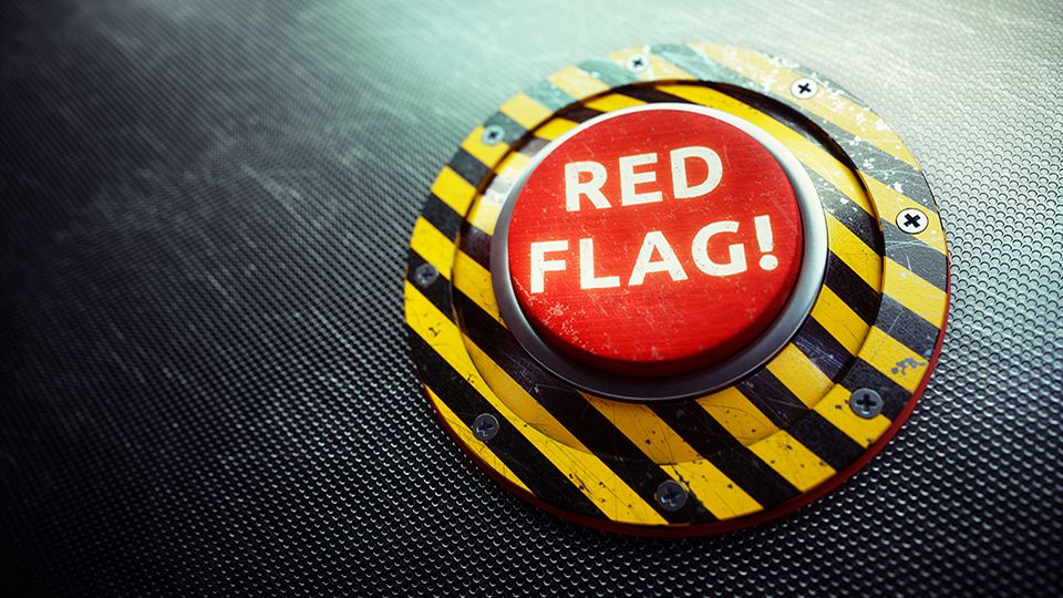 A conceptual mechanism with a red button and the words "RED FLAG" written on it