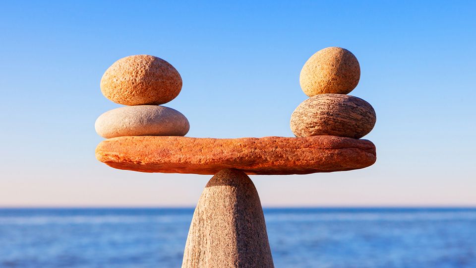 Symbolic scale of the stones on sea background closeup. Concept of harmony and balance. work-life, emotional balance