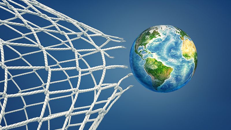 3d rendering of realistic ball colored like an Earth globe flies through a torn football net. International sport. Worldwide competition. Sport for peace. Elements of this image are furnished by NASA (http://visibleearth.nasa.gov/)