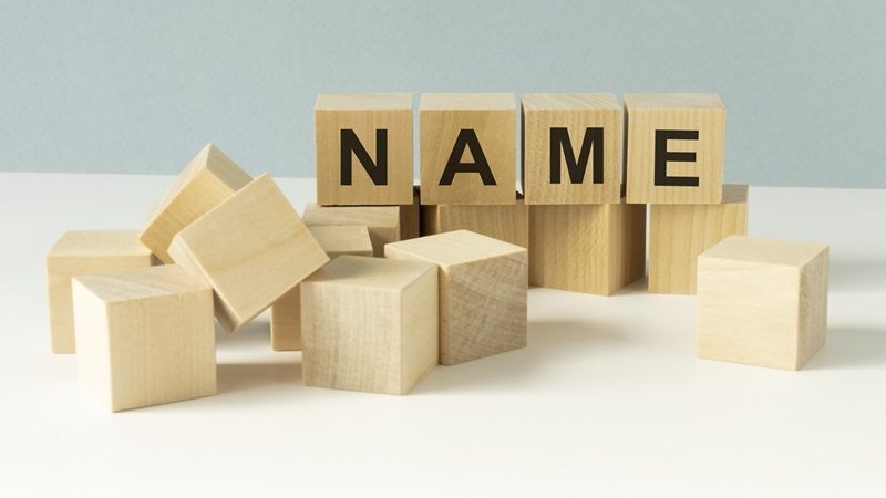 word name on wooden cubes, letters in black