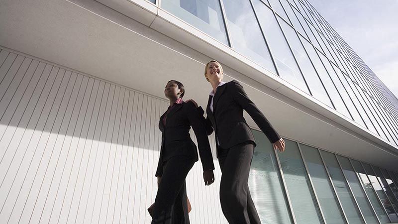 Businesswomen walking outside building