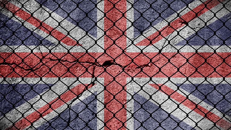 Flag of Great Britain and a fence on the border