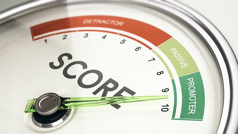 Concept of KPI, key performance indicator, Net Promoter Score Gauge with needle pointing to promoter.